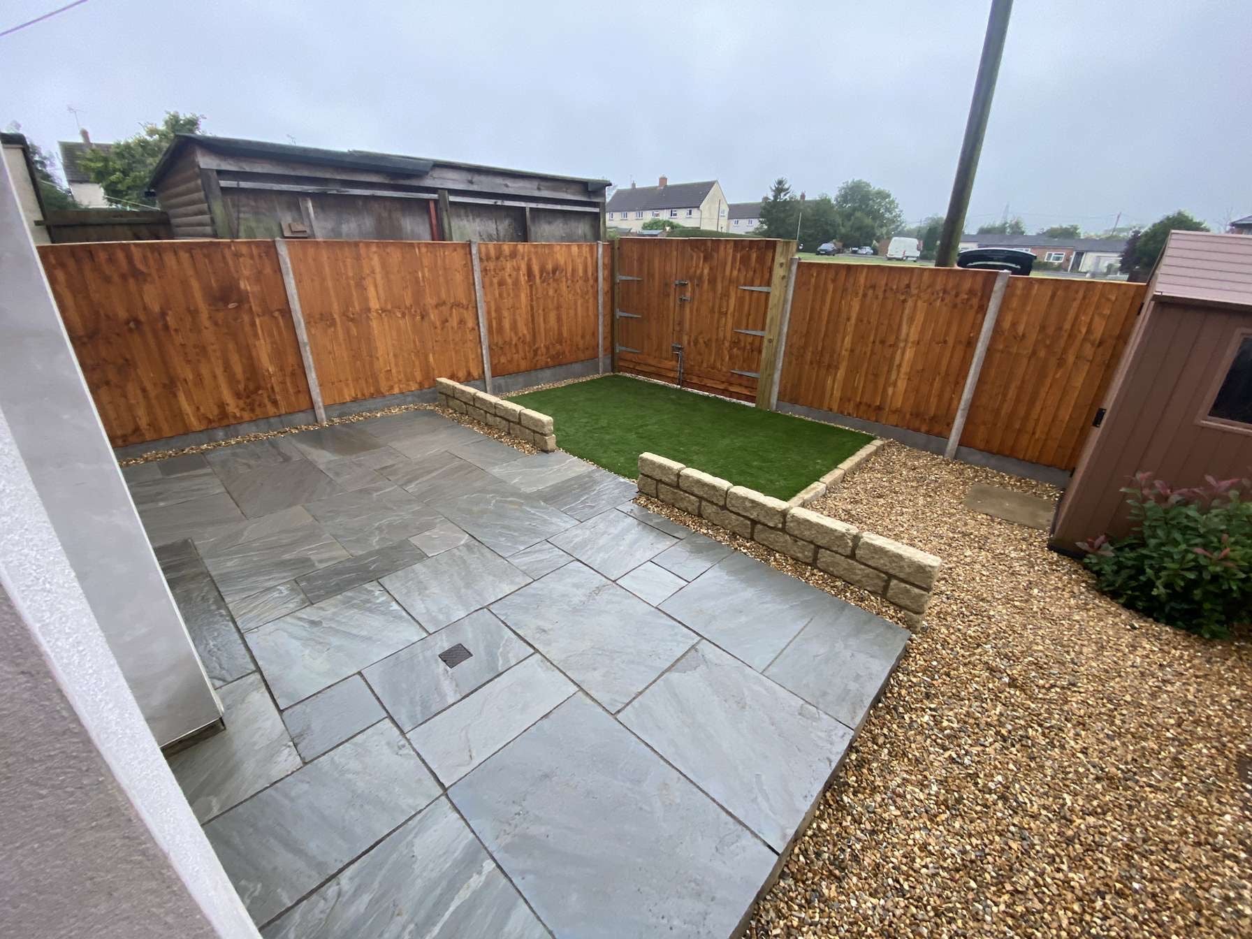 Renovation including patio, brick wall, artificial turf, fencing and shingle in Henley-On-Thames. 