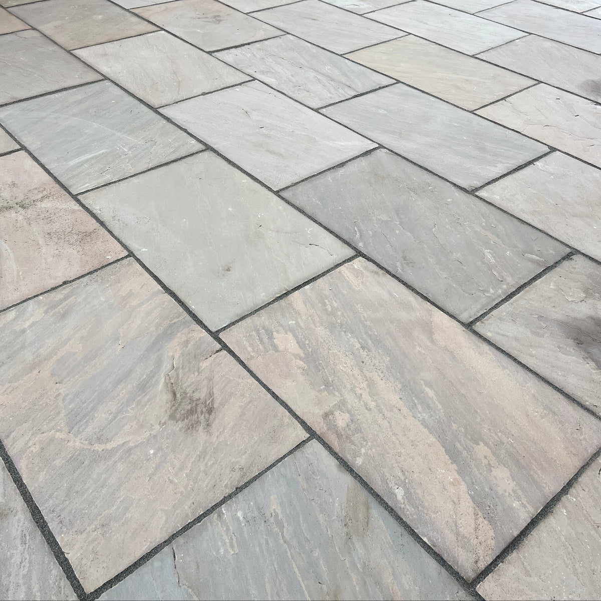 Close up image of Indian sandstone slabs in patio constructed by Earthscape Construction.