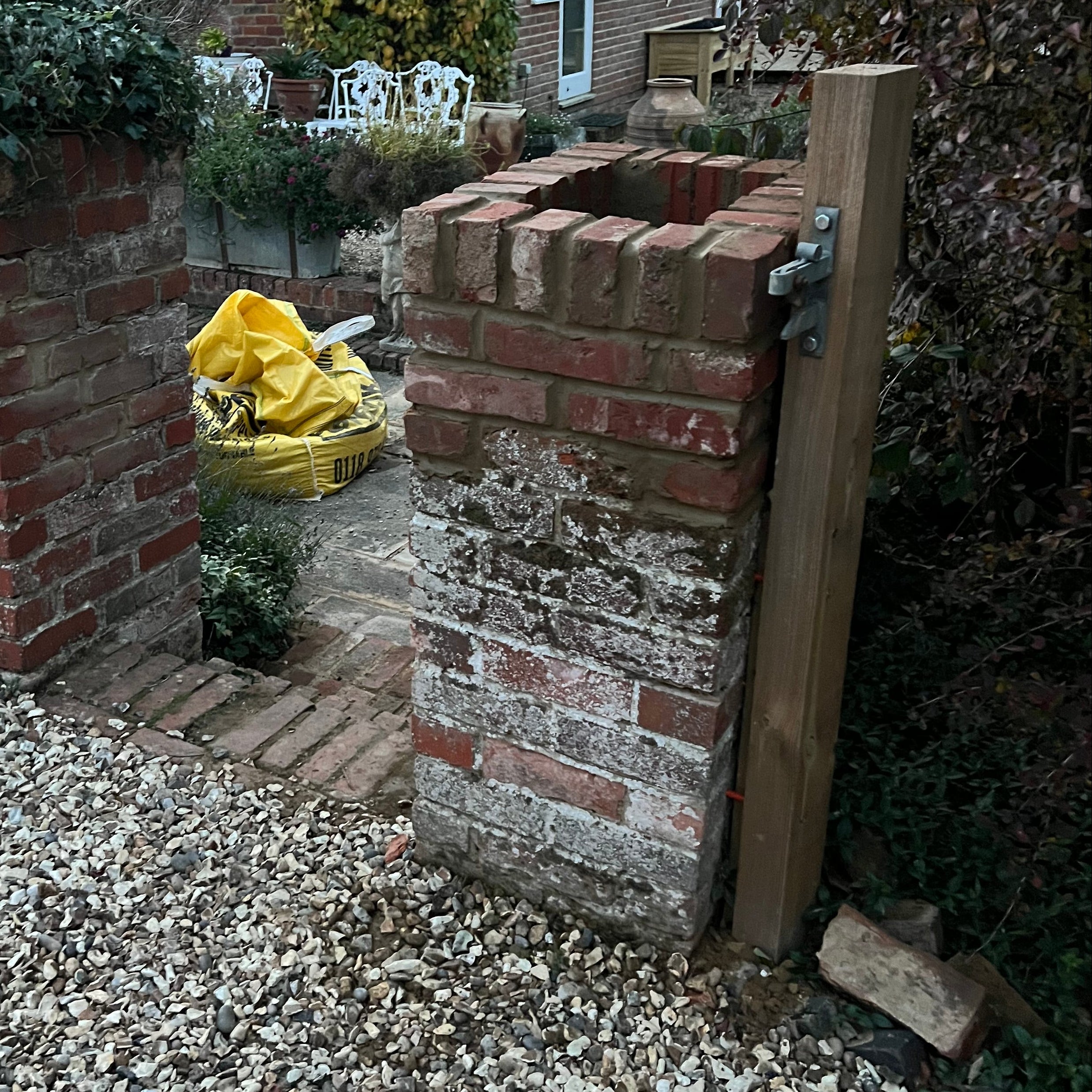 Redbrick pillar built next to patio and shingle drive in Binfield Heath.