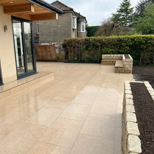 Porcelain paved large patio area with planter beds and steps.
