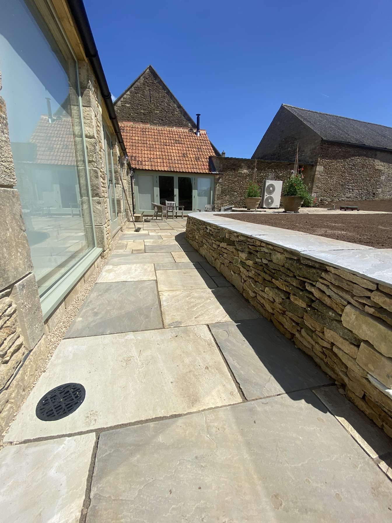 Patio and drystone wall built on farmhouse in Oxfordshire