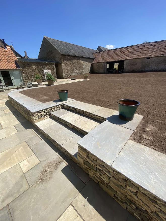 Garden renovation of farmhouse in Oxfordshire, patio and dry stone wall.