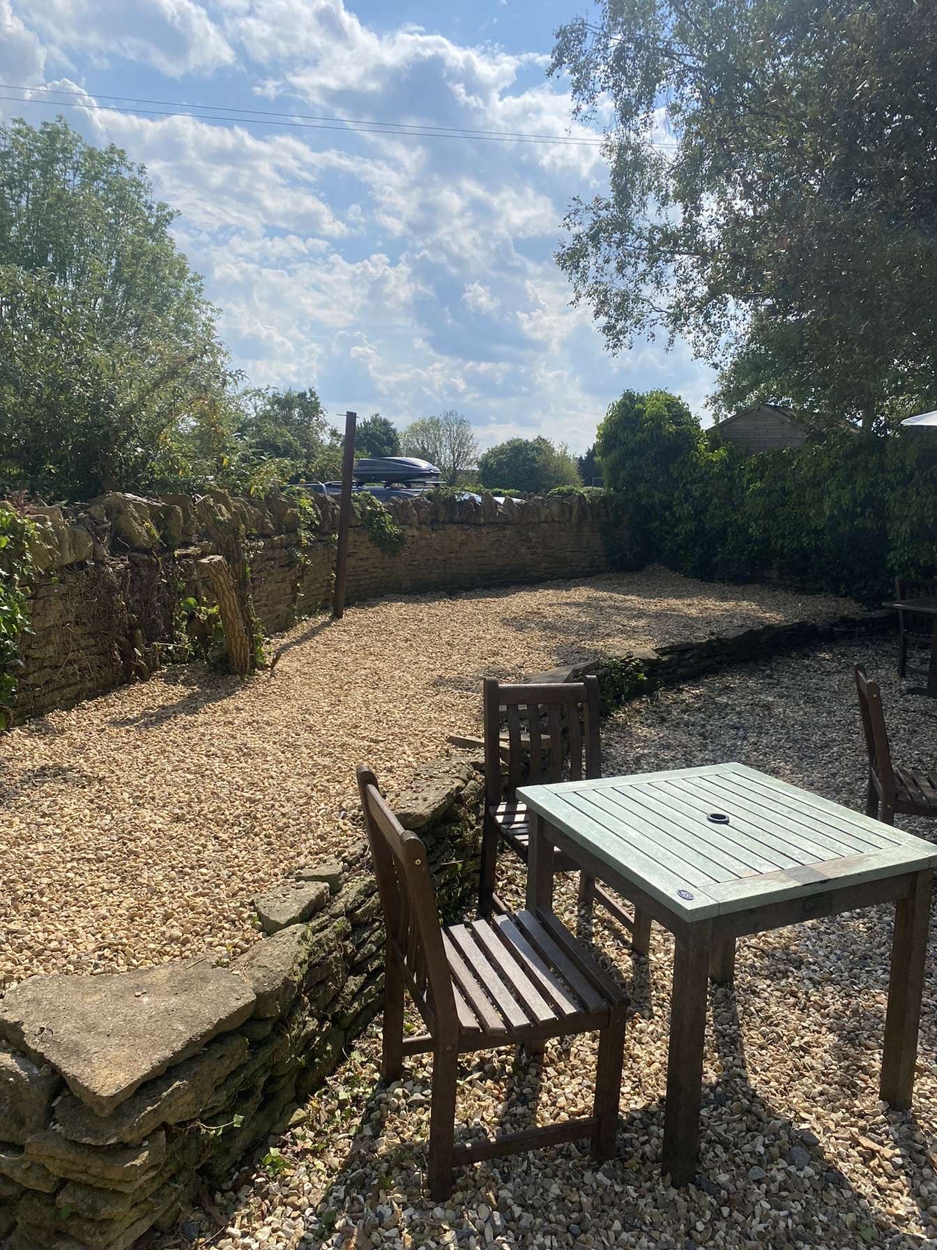 A pub garden with new gravel and weed membrane with garden furniture in.