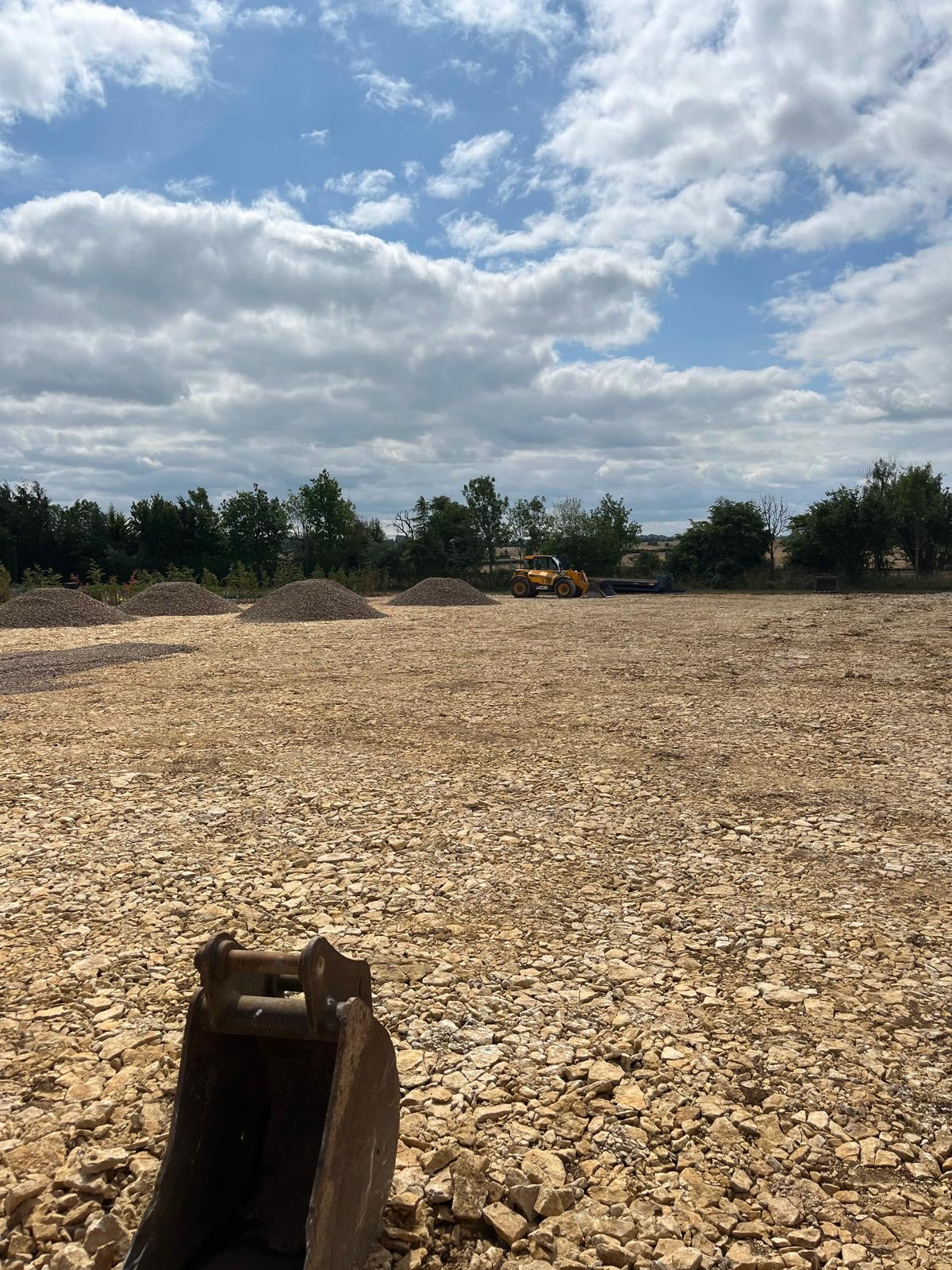 Open field in Watlington with a telehandler in distance.  