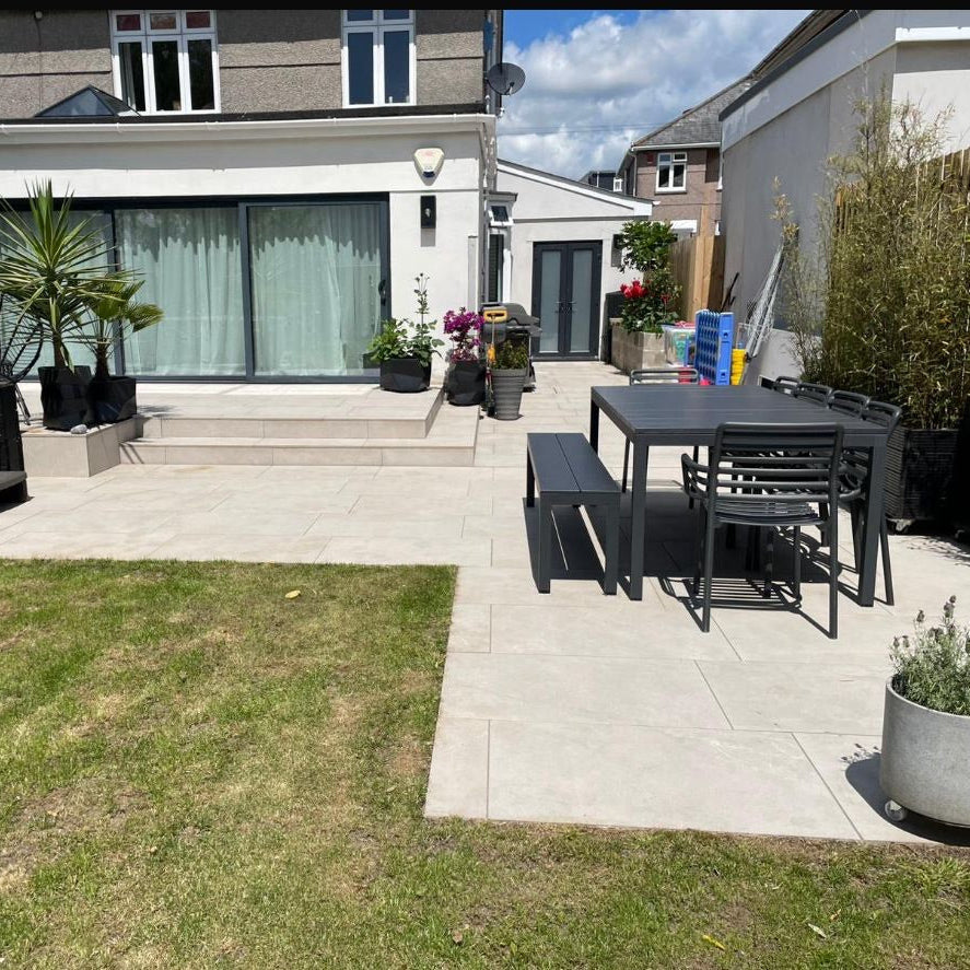 Porcelain patio with Pergola in Henley On Thames, with plants, grass and garden furniture.