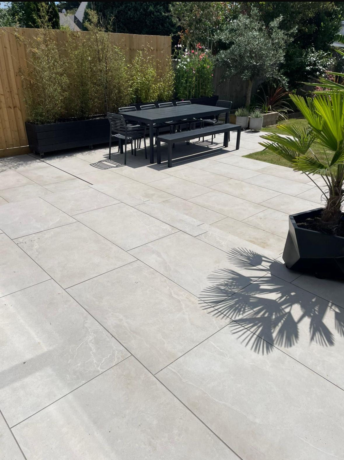 Patio with porcelain tiles, outdoor furniture, and plants in Wargrave.