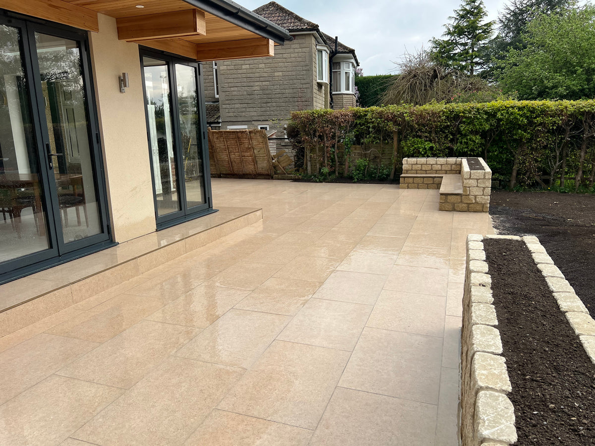 Large patio with planter beds in Henley-On-Thames garden.